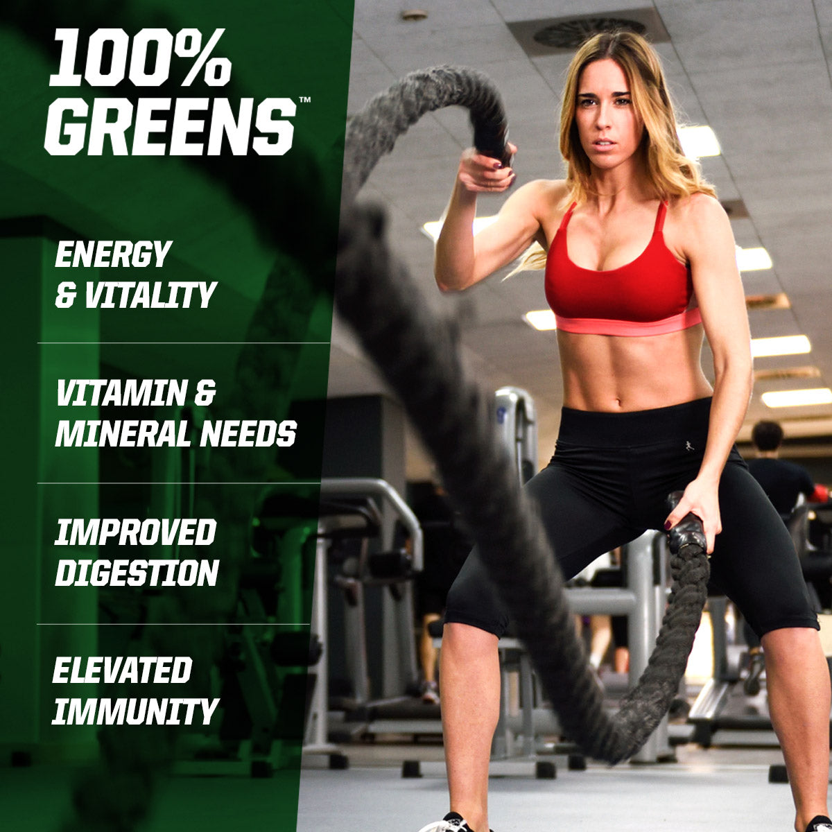 Woman using battle ropes in a gym with '100% Greens' supplement information on the left.