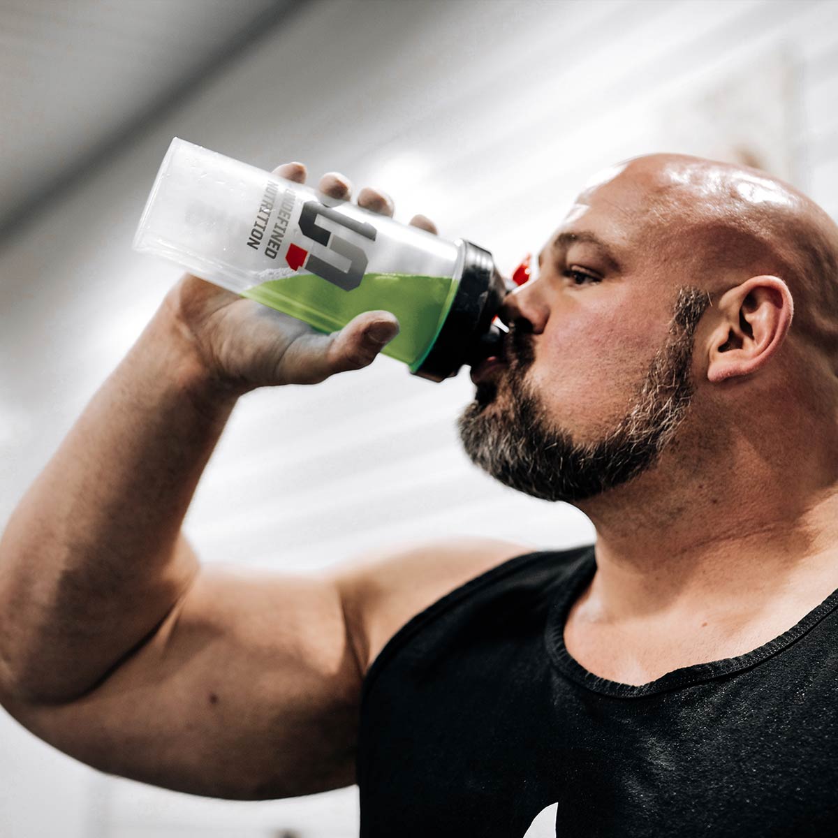 Brian Shaw drinking from a Gatorade shaker bottle against a neutral background
